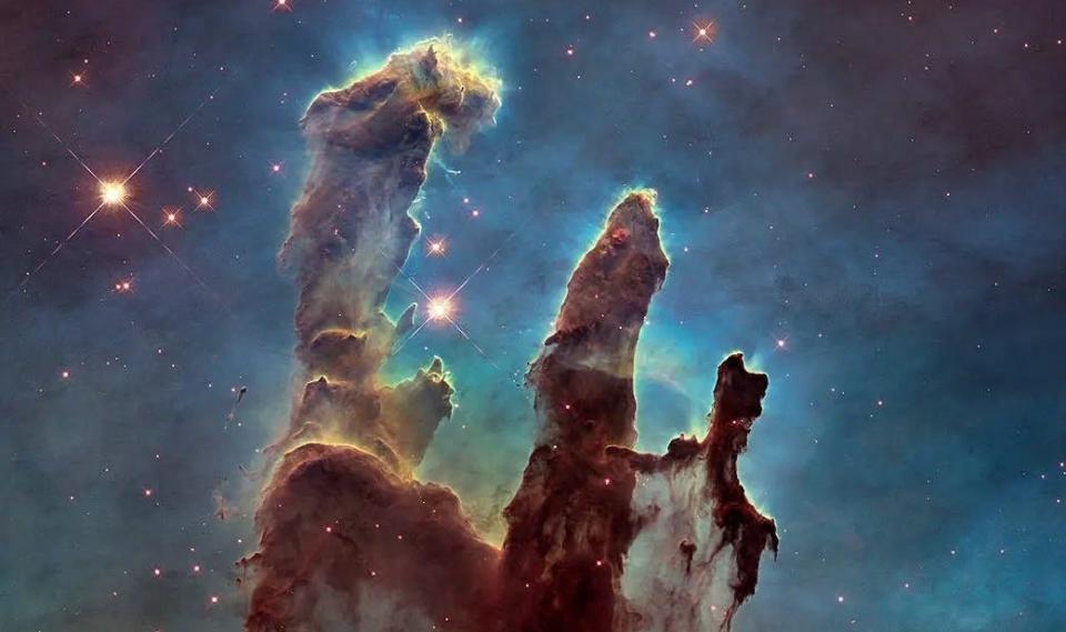 The star-forming dust structured known as the "Pillars of Creation," located in the center of Eagle Nebula, as pictured by the Hubble Space Telescope.