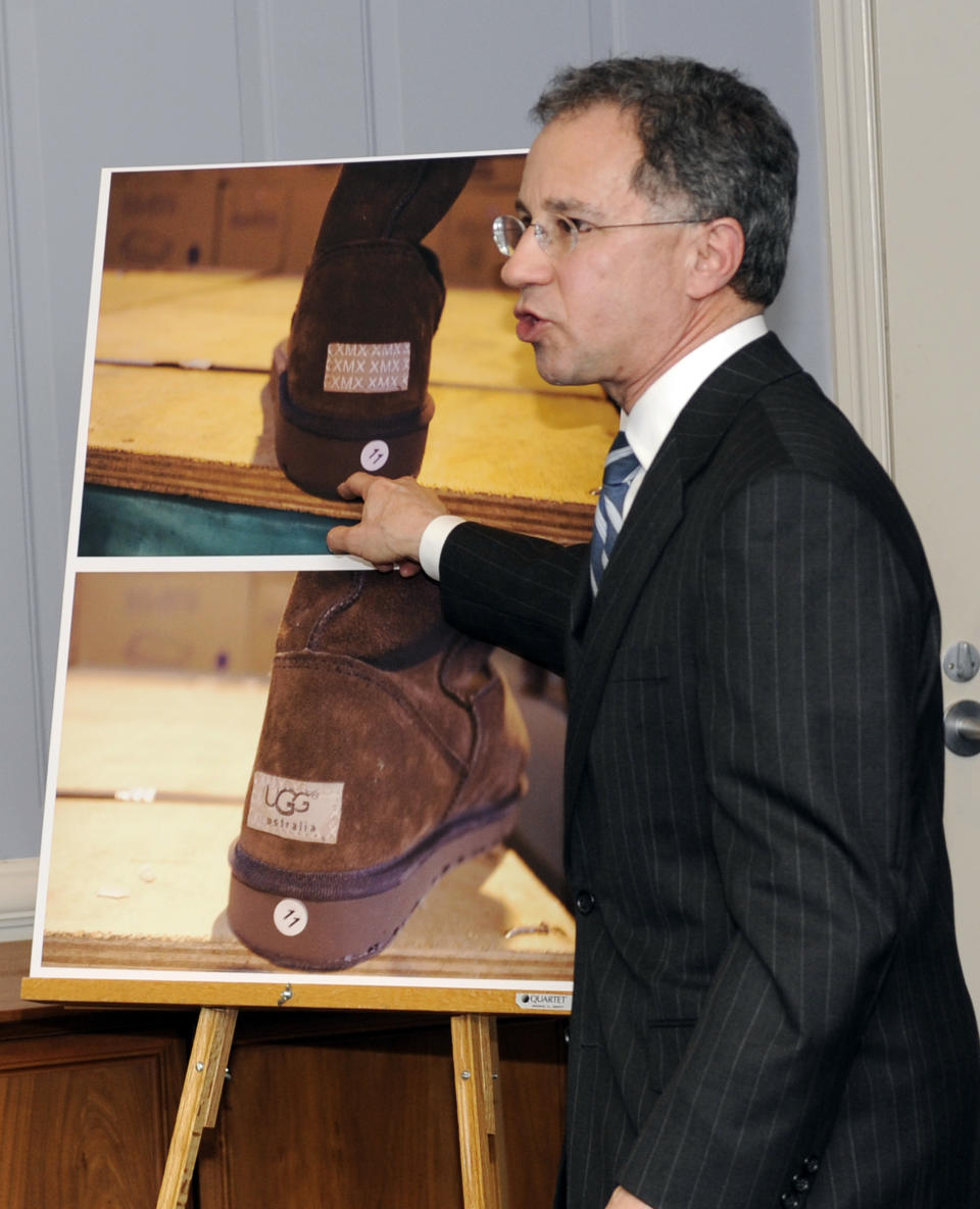 U.S. Attorney Paul J.Fishman points out how counterfeit UGG's boots were smuggled into the country at a news conference announcing the uncovering of one of the largest counterfeit goods smuggling operations ever charged Friday, March 2, 2012, in Newark, N.J. (AP Photo/Bill Kostroun)