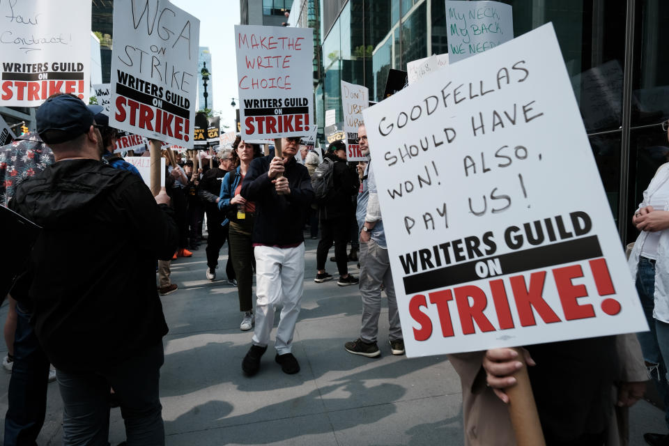 NEW YORK, NEW YORK - MAY 10: Members of the Writers Guild of America (WGA) East hold signs as they walk in the picket-line outside of HBO and Amazon's offices on May 10, 2023 in New York City. As the strike enters its second week, negotiations between a top guild and a trade association that represents Hollywood’s top studios failed to avert the first walkout in more than 15 years. Union members have stated that they are not being paid fairly in the streaming era and are seeking pay increases and structural changes to the business model.  (Photo by Spencer Platt/Getty Images)