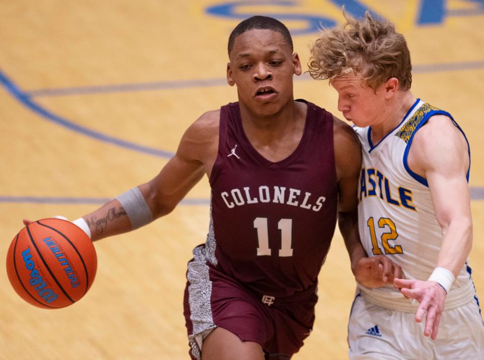 Castle’s Jackson Mitchell (12) guards Henderson County's Gerard Thomas (11) during their game at Castle High School Tuesday night, Jan. 18, 2022.