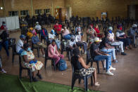 People who have just received their jab against COVID-19 Friday Dec. 3, 2021 wait for their vaccine card to be processed at the Orange Farm, South Africa, multipurpose center. South Africa has accelerated its vaccination campaign a week after the discovery of the omicron variant of the coronavirus. (AP Photo/Jerome Delay)