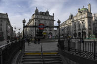 A near empty Piccadilly Circus, in London, Tuesday, Nov. 24, 2020. Haircuts, shopping trips and visits to the pub will be back on the agenda for millions of people when a four-week lockdown in England comes to an end next week, British Prime Minister Boris Johnson said Monday. (AP Photo/Alberto Pezzali)