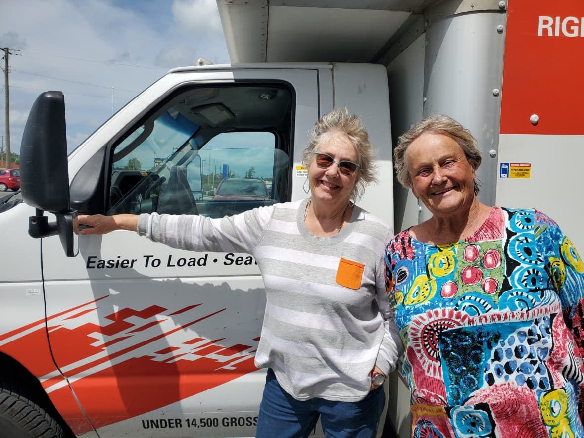 Gail Bridgeman, left, and Karen Burke couldn't find a rental car for their trip to Newfoundland, so they decided to rent a U-Haul moving van. (Jane Adey/CBC - image credit)