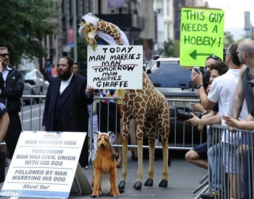 A protestor holds signs against same-sex marriage during the 2012 New York Gay Pride parade in New York. The 43rd-annual parade with more than 500,000 people is part of Gay Pride week