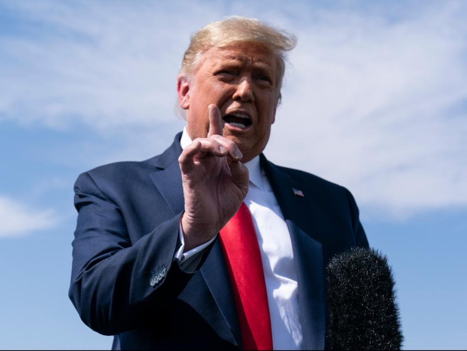 President Donald Trump speaks with reporters after stepping off Air Force One at Phoenix Sky Harbor International Airport (AP)