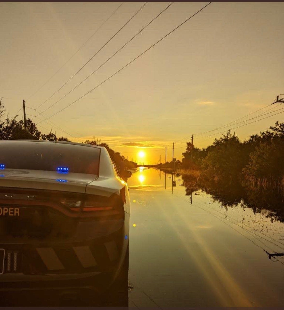 Florida Highway Patrol troopers block off State Road 46 as flooding continues.