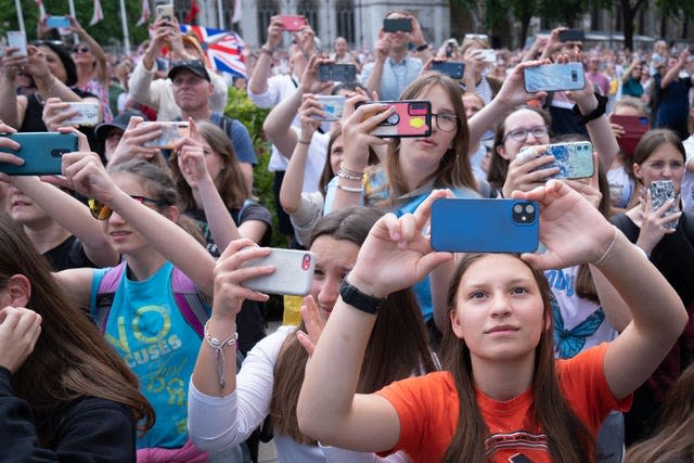Crowds in Parliament Square take photographs of the Jubilee flypast