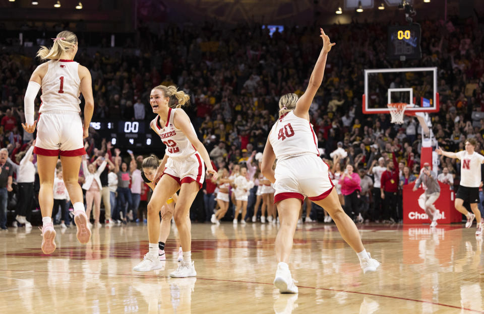 Nebraska's Jaz Shelley (1), Natalie Potts (22) and Alexis Markowski (40) celebrate after a win over Iowa in an NCAA college basketball game Sunday, Feb. 11, 2024, in Lincoln, Neb. (AP Photo/Rebecca S. Gratz)