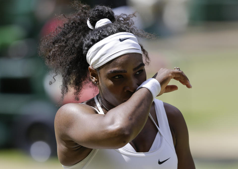Serena Williams of the United States wipes her face, during the women's singles final against Garbine Muguruza of Spain, at the All England Lawn Tennis Championships in Wimbledon, London, Saturday July 11, 2015. (AP Photo/Pavel Golovkin)