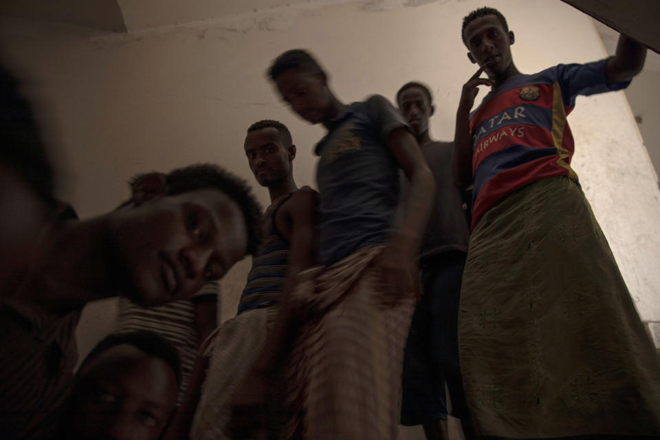 In this July 21, 2019 photo, Ethiopian migrants run down stairs in the "22nd May Soccer Stadium," where they took shelter, in Aden, Yemen. Over the summer, the stadium became a temporary refuge for thousands of migrants. At first, security forces used it to house migrants they captured in raids. Other migrants showed up voluntarily, hoping for shelter. The IOM distributed food at the stadium and arranged voluntary repatriation back home for some. The soccer pitch and stands became a field of tents, with clothes lines strung up around them. (AP Photo/Nariman El-Mofty)