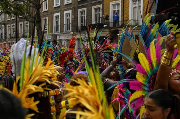A sea of masqueraders walk along the route of the Notting Hill Carnival parade down Ladbroke Grove. (Photo: Clara Watt for HuffPost)
