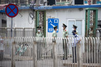 Paramilitary police stand guard on a street near the Xinfadi wholesale food market district in Beijing, Saturday, June 13, 2020. Beijing closed the city's largest wholesale food market Saturday after the discovery of seven cases of the new coronavirus in the previous two days. (AP Photo/Mark Schiefelbein)