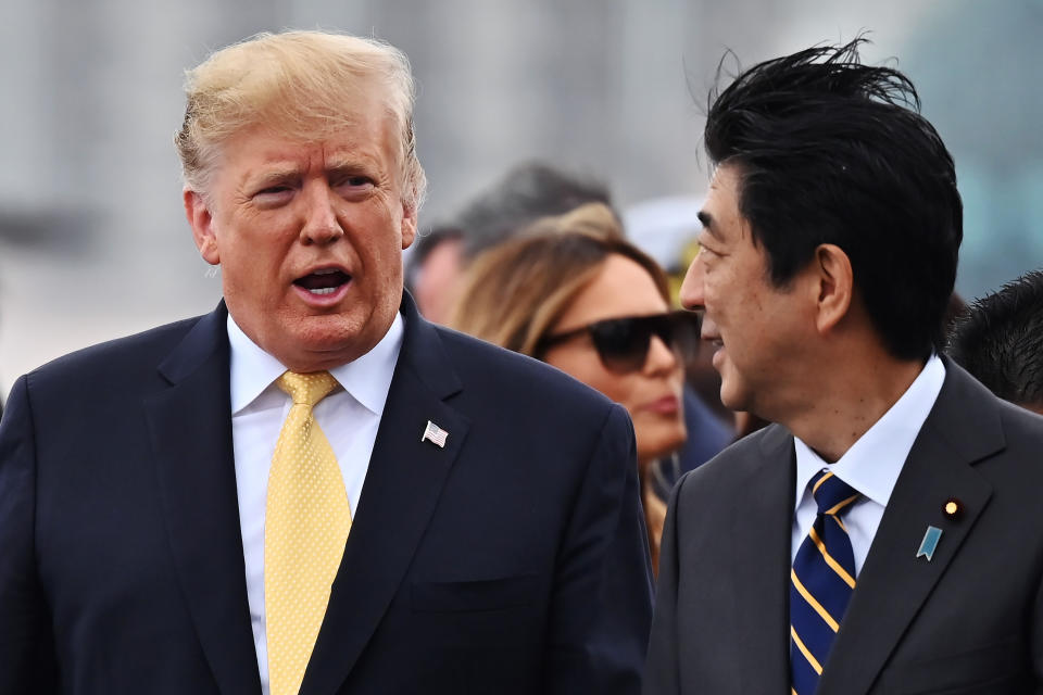 U.S. President Donald Trump, left, with Japan's Prime Minister Shinzo Abe, leaves the Japanese destroyer JS Kaga, after his tour in Yokosuka, south of Tokyo Tuesday, May 28, 2019. (Charly Triballeau/Pool Photo via AP)