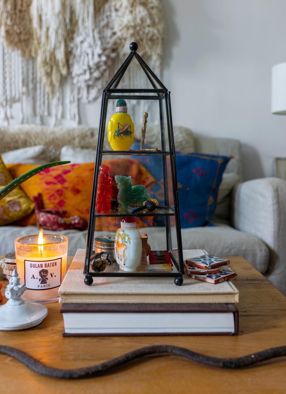 On the coffee table, which is from Restoration Hardware, is further evidence of Darroch’s travels. Here: an obelisk of antique opium bottles from Hong Kong.