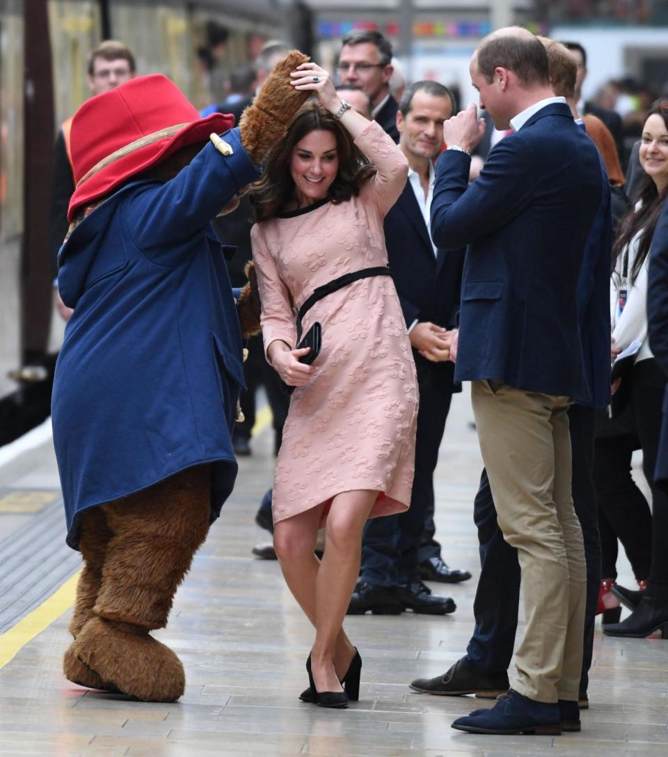 Kate dances with Paddington Bear during surprise visit to London station (Chris J Ratcliffe/AFP/Getty Images)