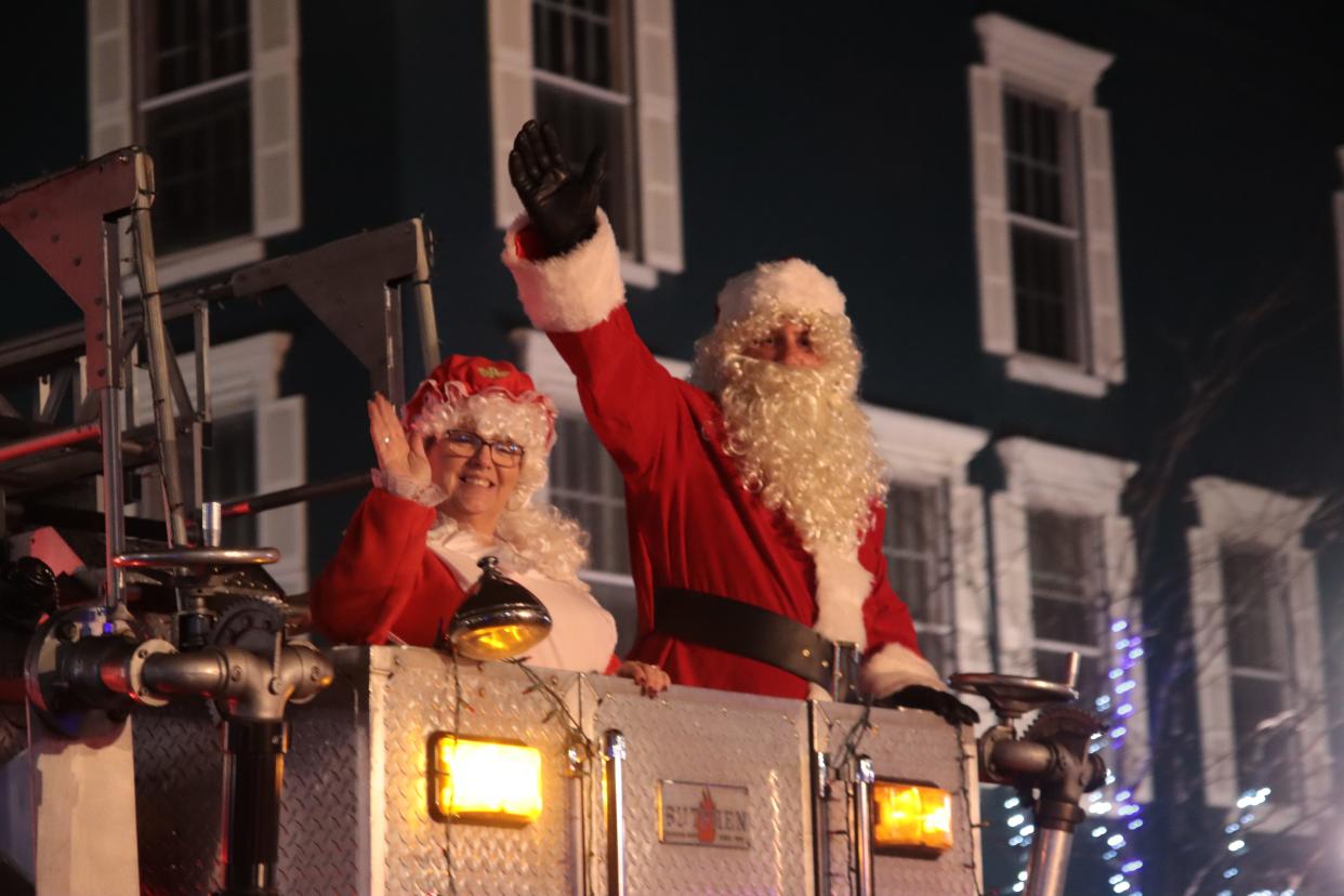 Mrs. and Santa Claus wave to the crowd from the basket of the Adrian Fire Department's aerial tower Dec. 3, 2021, during the Adrian Holiday Lights Parade. This year's parade is at 6:30 p.m. Dec. 2.