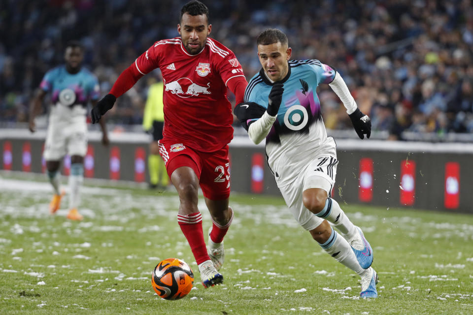 New York Red Bulls midfielder Cristian Cásseres Jr, left, races for the ball against Minnesota United midfielder Franco Fragapane, right, in the second half of an MLS soccer game Saturday, March 11, 2023, in St. Paul, Minn. (AP Photo/Bruce Kluckhohn)