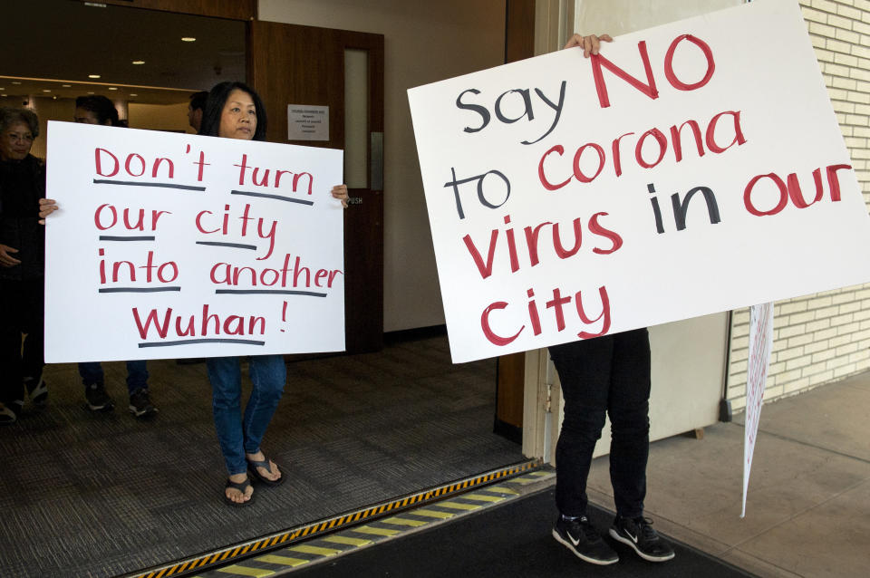 Mary Cahill, left, leaves a news conference where officials discussed the proposal for housing coronavirus patients at the Fairview Development Center in Costa Mesa, Calif., Saturday, Feb. 22, 2020. A court temporarily blocked the U.S. government from sending up to 50 people infected with a new virus from China to the Southern California city for quarantine after local officials argued that the plan lacked details about how the community would be protected from the outbreak. (Mindy Schauer/The Orange County Register via AP)