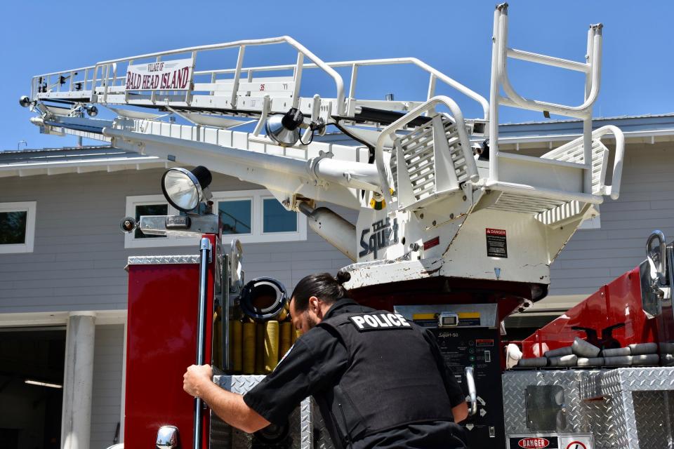 Bald Head Island public safety officer Chip Sudderth extends the ladder on the department's only ladder truck on Wednesday, April 27, 2022.