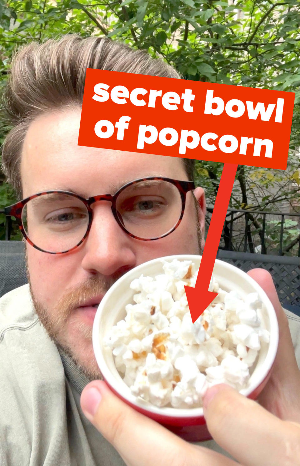 the author holding a cup of popcorn with the words "secret bowl of popcorn"