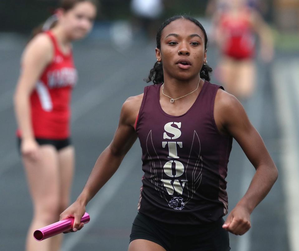 Stow anchor Jayla Atkinson races away after getting the baton in the 3,200-meter relay during the 2024 Suburban League National Conference track meet.