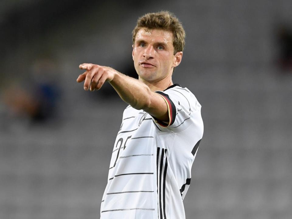 Thomas Muller points during a Germany soccer match.