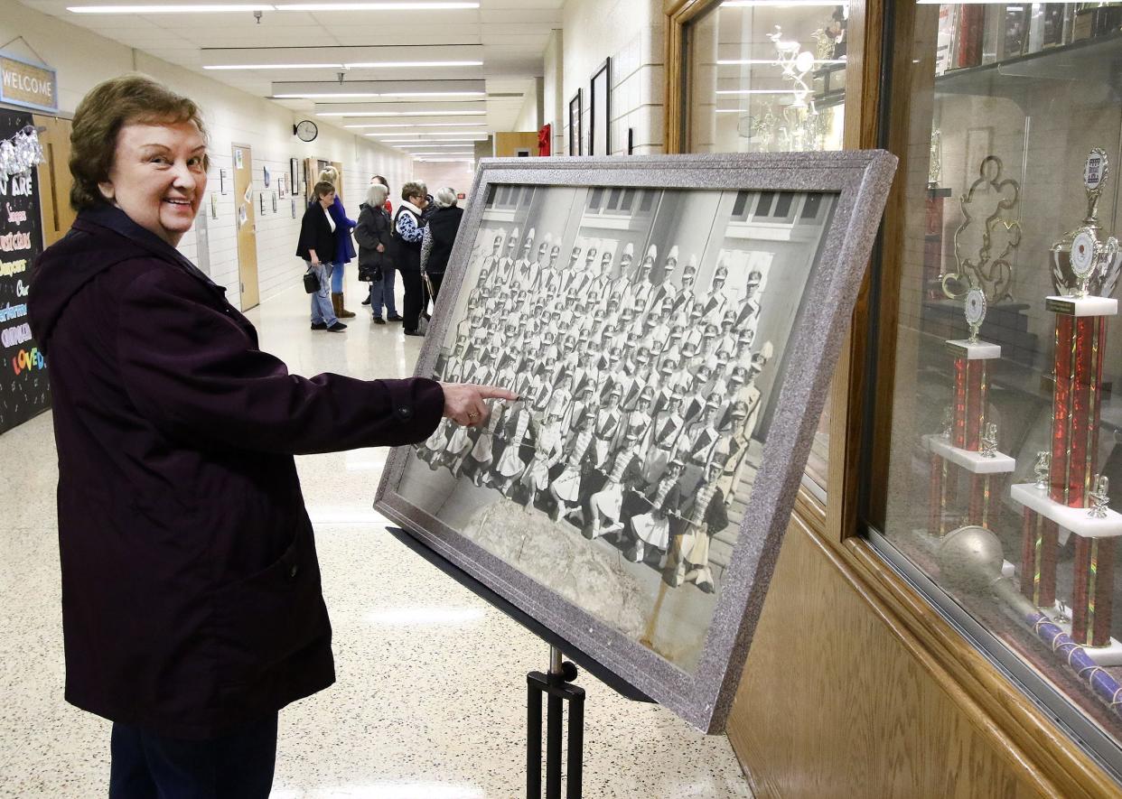 Alliance graduate and former marching band member Gloria (Poland) Bollinger points to herself in a 1962 Aviator Marching Band photo. She and other former band members gathered Jan. 28 to take a group photo to send to former director John E. Weitzel to celebrate his 99th birthday. Ed Hall Jr. / Special To The Review