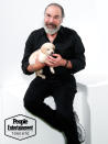 <p>Patinkin looks willing to <em>fur</em>-give the tiny pup for nibbling at his fingers. </p>