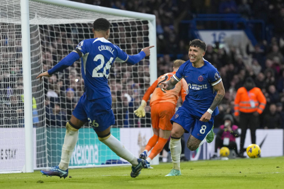 Chelsea's Enzo Fernandez, right, celebrates with his teammate Levi Colwill after he scored his side's third goal during the English Premier League soccer match between Chelsea and Brighton and Hove Albion, at Stamford Bridge stadium in London, Sunday, Dec. 3, 2023. (AP Photo/Alastair Grant)