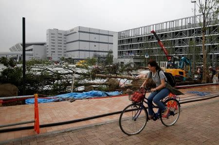 A woman cycles past the new Tokyo Metropolitan Central Wholesale Market, known as Toyosu market, which will take over from the famous Tsukiji market, under construction in the Toyosu district in Tokyo, Japan, September 27, 2016. REUTERS/Toru Hanai