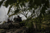 Ukrainian servicemen stand on Ukrainian Soviet-made T-64 tank, in Bakhmut, Ukraine, Sunday, Oct. 2, 2022. (AP Photo/Inna Varenytsia)