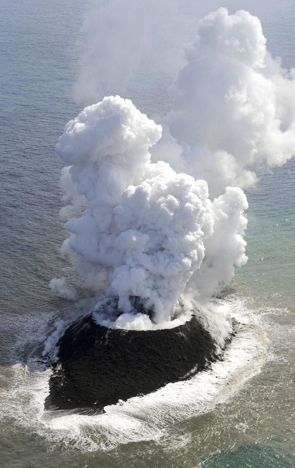 Smoke from an erupting undersea volcano forms a new island off the coast of Nishinoshima in the southern Ogasawara chain of islands