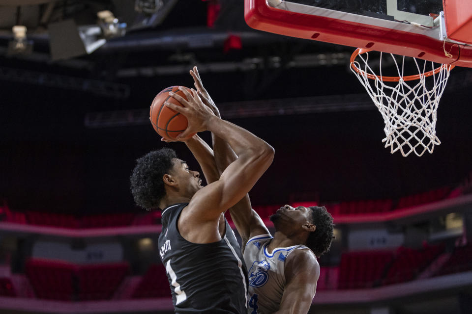 Drake's Sardaar Calhoun blocks Mississippi State's Tolu Smith in the first half during an NCAA college basketball game, Tuesday, Dec. 20, 2022, in Lincoln, Neb. (AP Photo/John S. Peterson)