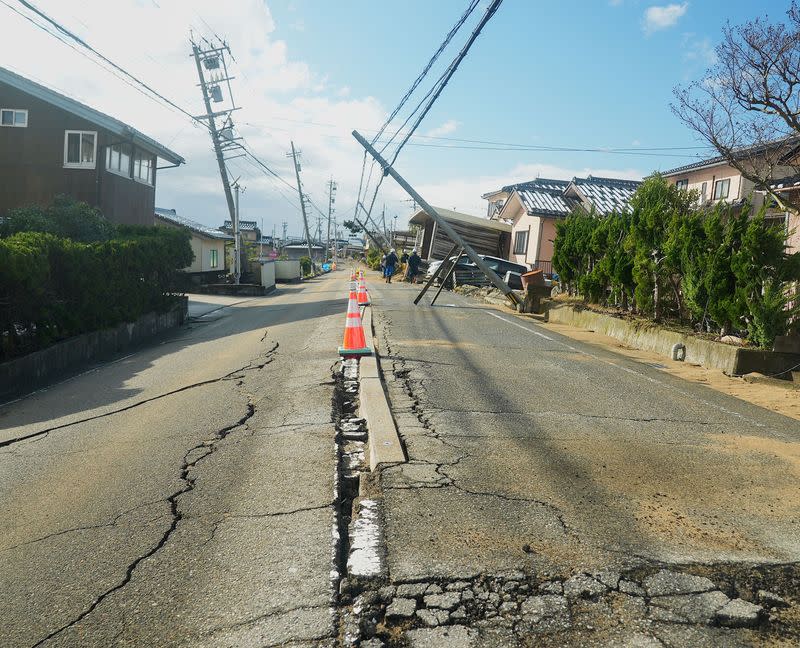Traffic cones are arranged along a road damaged by the January 1 earthquake in Nishiaraya