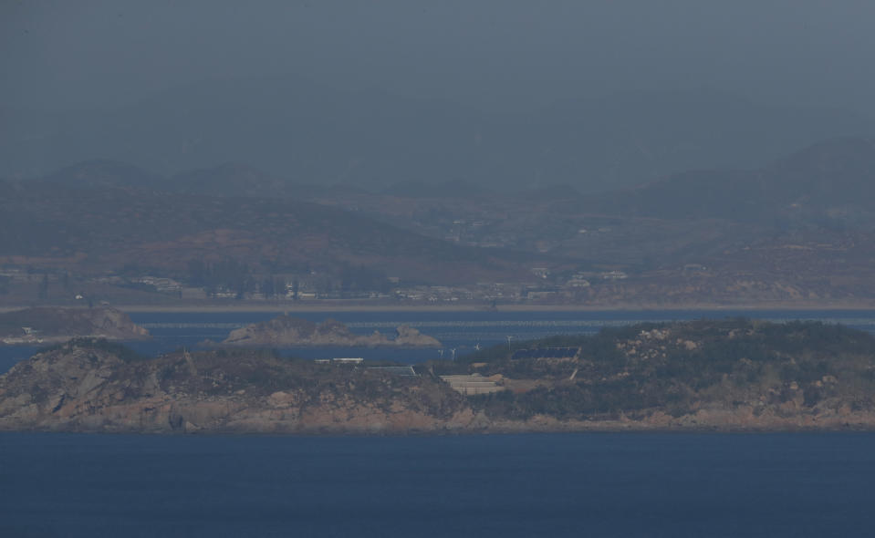 Jangjae Island on the North Korean side is seen from South Korea's western island of Yeonpyeong, South Korea, Thursday, Nov. 1, 2018. The U.S. and South Korea are reviewing whether they will conduct large-scale military exercises next year and will decide before December. South Korean Defense Minister Jeong Kyeong-doo told reporters Wednesday at the Pentagon that if more exercises are suspended the two countries will conduct other training to mitigate the lapse. He says the review will be done by Nov. 15. (Jeon Heon-kyun/Pool Photo via AP)