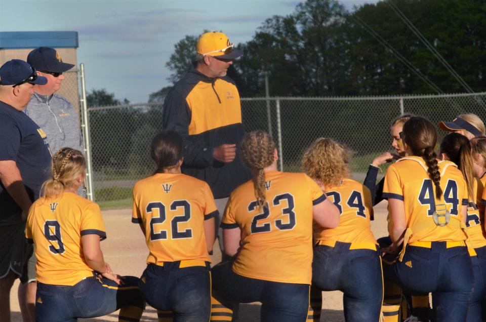 Coach Greg Jones addresses the team after a high school softball matchup between Gaylord and Traverse City Central on Tuesday, May 16.