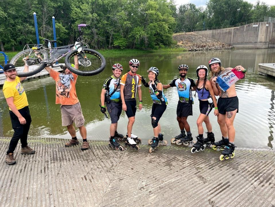 Jen Shyu (fourth from right) and Arnav "Sonic" Shah (third from right) with their team of inline skaters doing the "tire dip" at the Mississippi River in 2021.