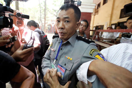 Prosecution witness police captain Moe Yan Naing walks outside the court room during a hearing of detained Reuters journalists Wa Lone and Kyaw Soe Oo in Yangon, Myanmar April 20, 2018 . REUTERS/Ann Wang