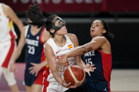 Spain's Cristina Ouvina is fouled by France's Gabrielle Williams (15) while driving to the basket during a women's basketball quarterfinal round game at the 2020 Summer Olympics, Wednesday, Aug. 4, 2021, in Saitama, Japan. (AP Photo/Charlie Neibergall)