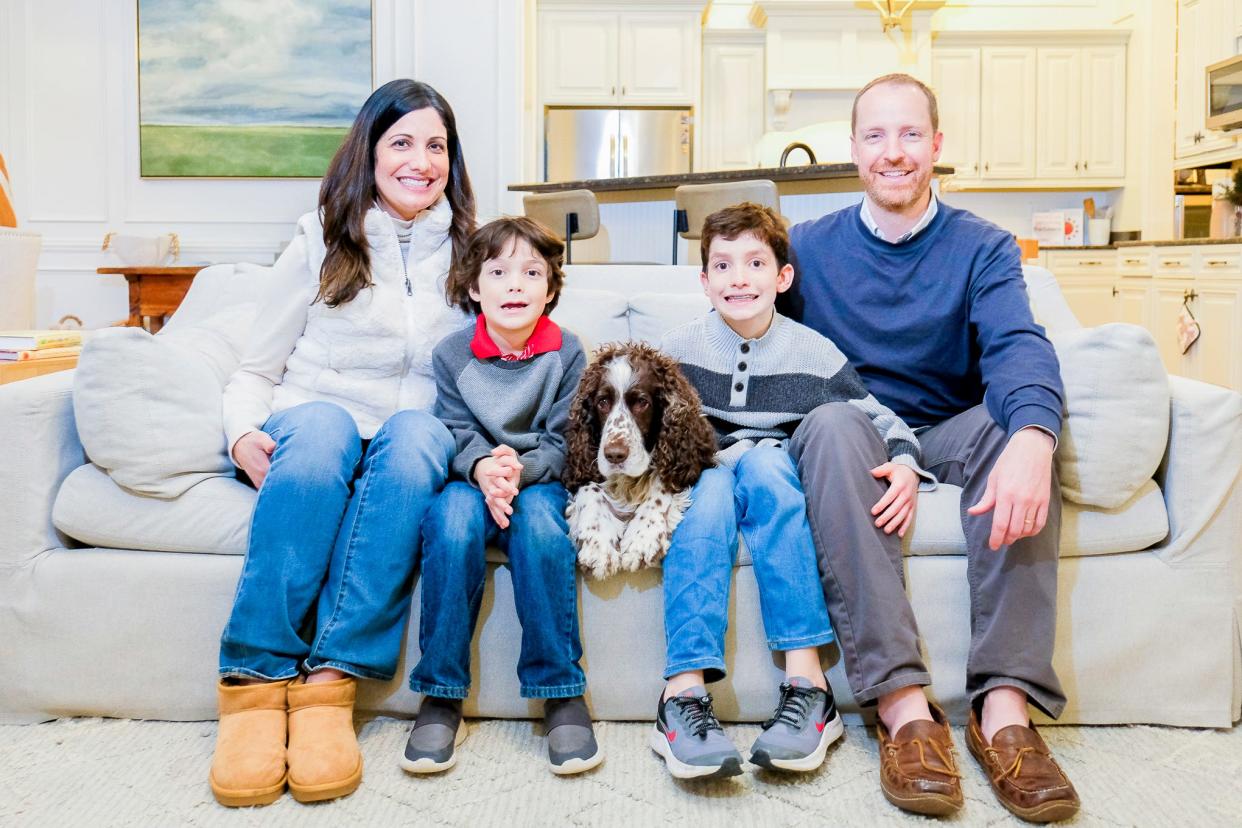 Cassandra, Oliver, Elliott and Seth Salley surround their canine companion.