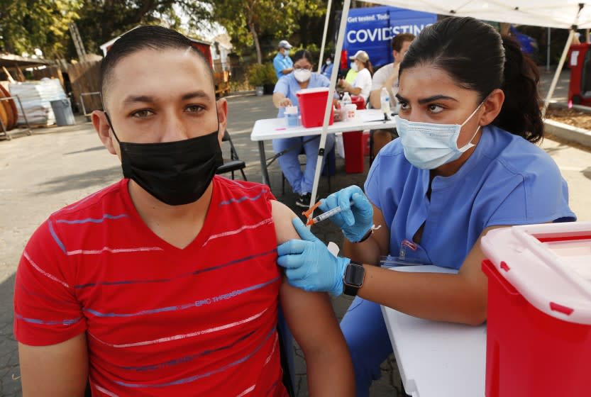 LOS ANGELES, CA - JULY 23: Pedro Antonio Tobar Mendoza, 28, visiting from El Salvador gets the Johnson and Johnson vaccine from Registered Nurse Jonica Portillo at the Pico Union Project located at 1153 Valencia where Curative is offering Covid testing and a choice of Pfizer or Johnson and Johnson Covid vaccine on Friday morning. We're asking the few that attended what has finally motivated people to get vaccinated. Pico Union Project on Friday, July 23, 2021 in Los Angeles, CA. (Al Seib / Los Angeles Times).