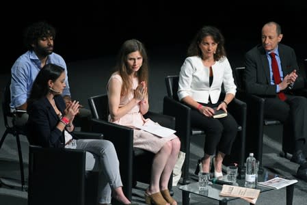 Amanda Knox, who has returned to Italy for the first time since being cleared of the murder of British student Meredith Kercher, greets the audience after speaking at the Criminal Justice Festival in Modena