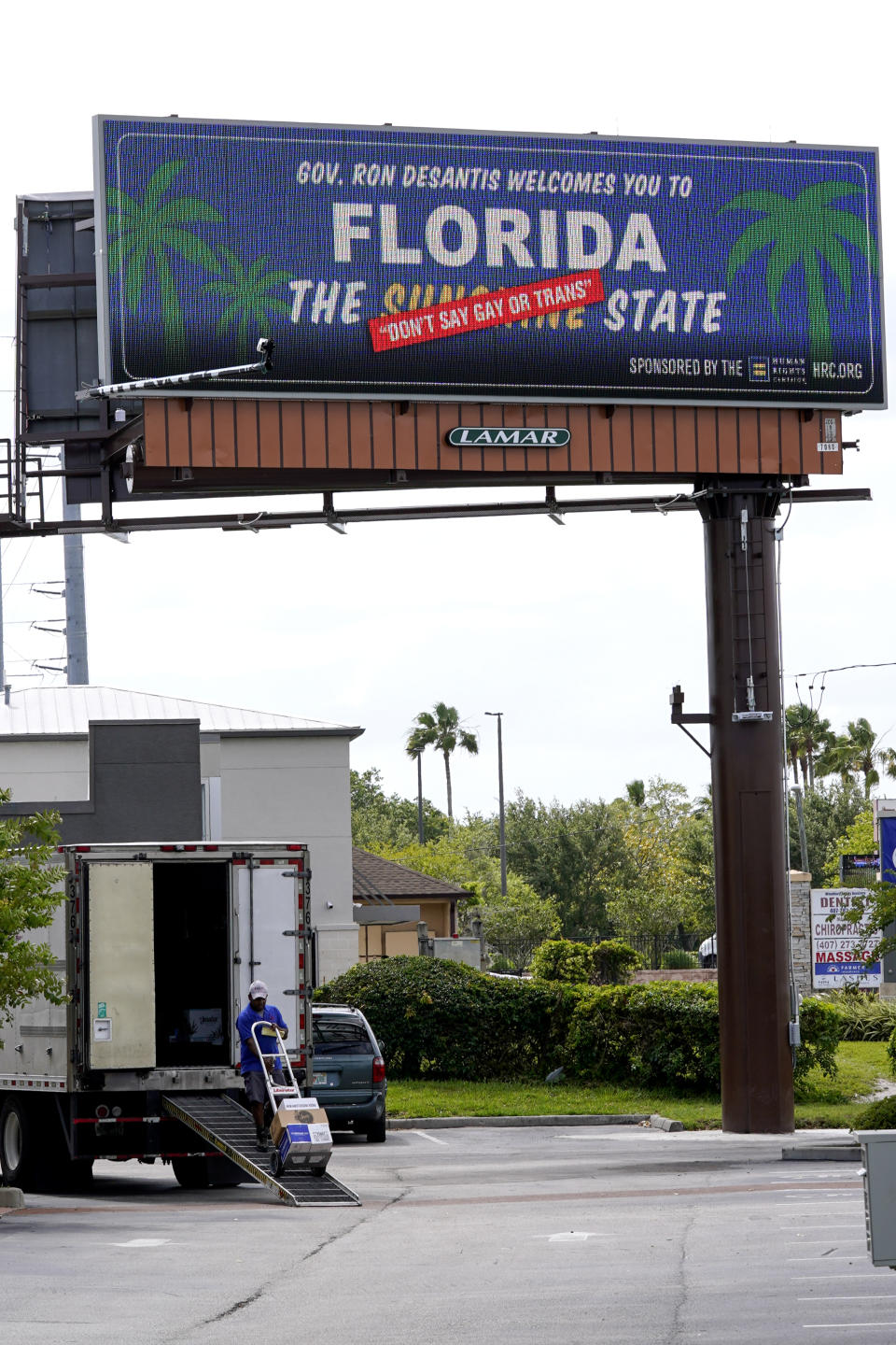 FILE - A new billboard welcoming visitors to "Florida: The Sunshine 'Don't Say Gay or Trans' State. is displayed April 21, 2022, in Orlando, Fla. The Florida Legislature has passed a bill to dissolve a private government controlled by Disney that provides municipal-like services for its 27,000 acres in the Sunshine State. The proposal has been pushed by Republican Gov. Ron DeSantis, and is largely viewed as retribution for Disney’s criticism of a new state law that bars instruction on sexual orientation and gender identity in kindergarten through third grade. (AP Photo/John Raoux, File)