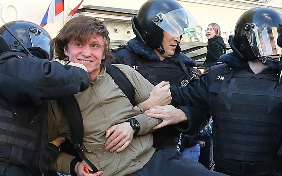 Riot police detain a protester in Moscow - Credit: TASS / Barcroft Images