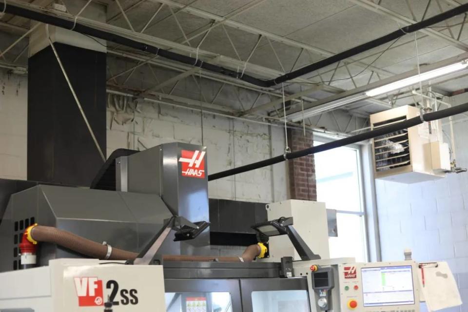 NEMCCs new precision manufacturing machines sit a few feet away from a wall with visible water damage. Molly Minta/Mississipp[ Today