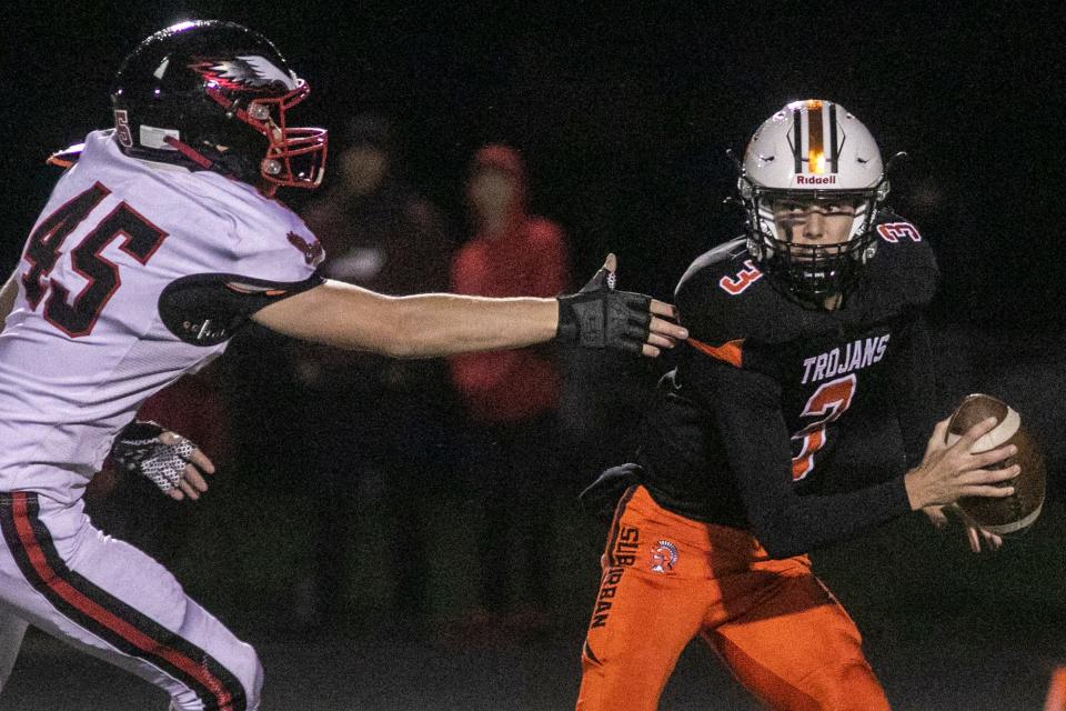York Suburban quarterback Rylan Bratton is pressured by a defender during a YAIAA Division II football game against Dover at York Suburban High School, Friday, September 30, 2022. The Eagles won, 35-21.