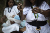 An Arhuaco Indigenous woman weaves a bag in Nabusimake on the Sierra Nevada de Santa Marta, Colombia, Monday, Jan. 16, 2023. The life of the Arhuacos is closely tied to the Sierra Nevada de Santa Marta. Their white garments represent snow and the men´s conical hats represent the snowy peaks of the Sierra Nevada. (AP Photo/Ivan Valencia)