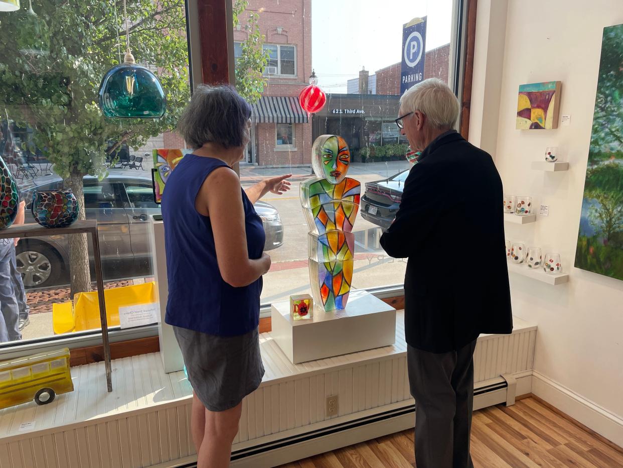 Gov. Tony Evers admires art that is on display at SOMI Gallery in downtown Sturgeon Bay on Sept. 14.