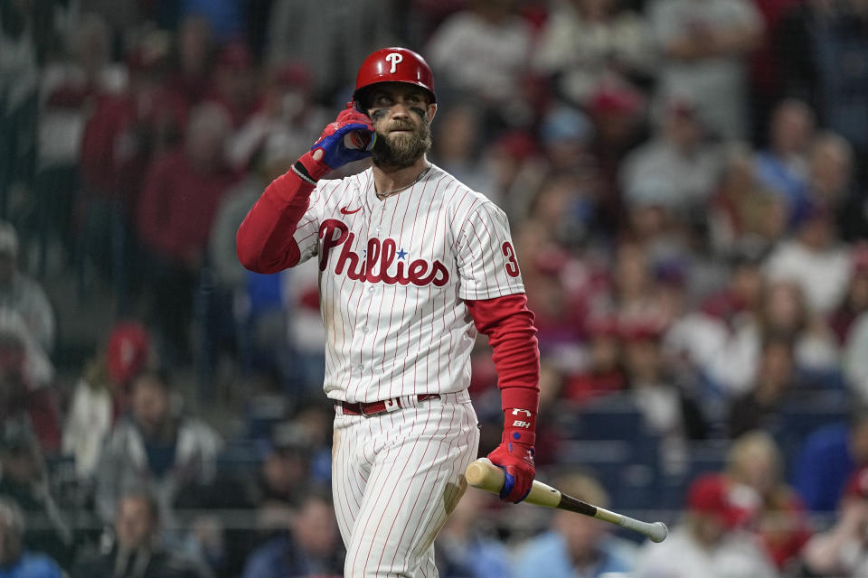 Philadelphia Phillies' Bryce Harper walks to the dugout after striking out during the fourth inning in Game 4 of baseball's World Series between the Houston Astros and the Philadelphia Phillies on Wednesday, Nov. 2, 2022, in Philadelphia. (AP Photo/David J. Phillip)