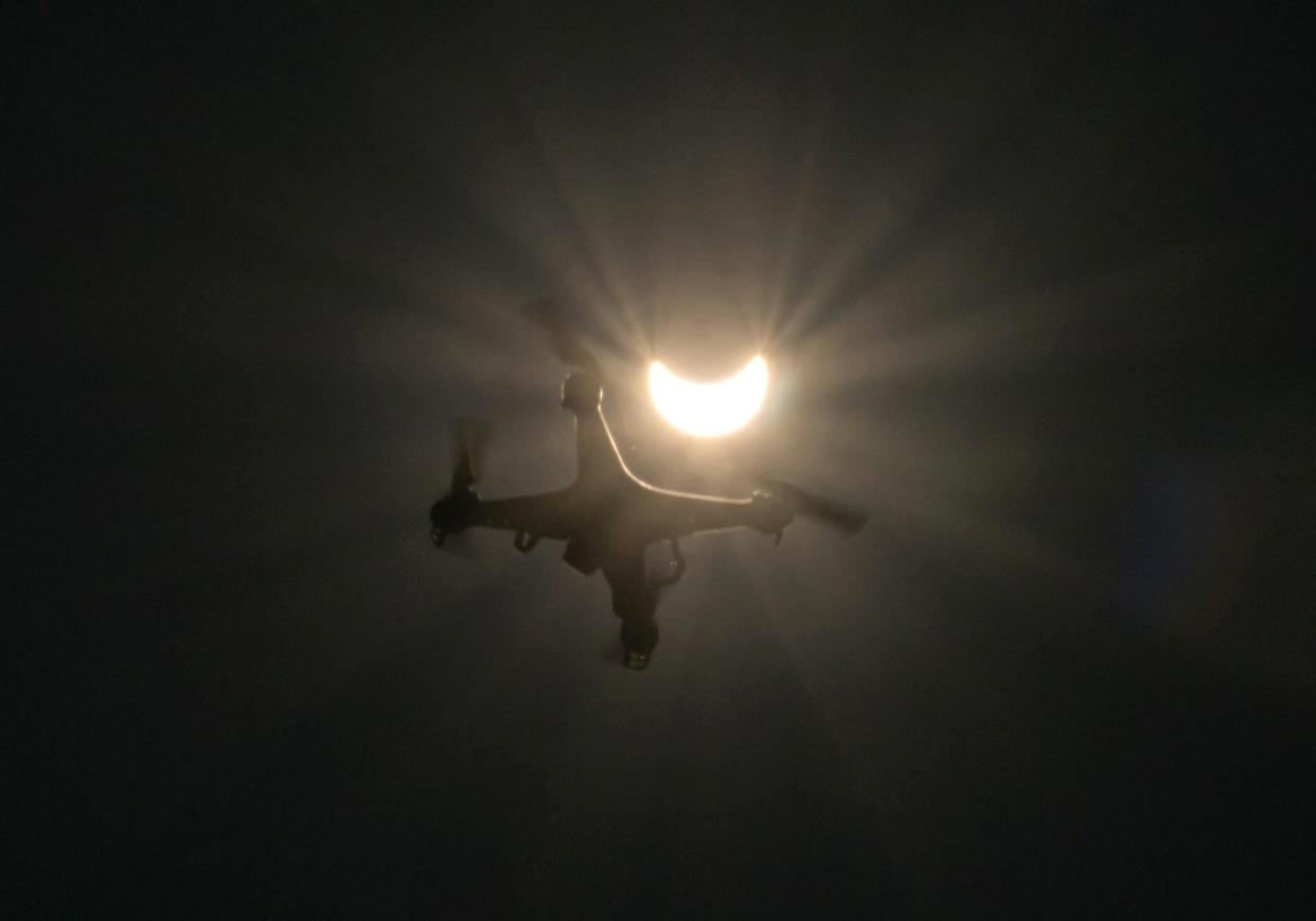 A drone flies in foreground of a partial solar eclipse in Vienna: JOE KLAMAR/AFP/Getty Images